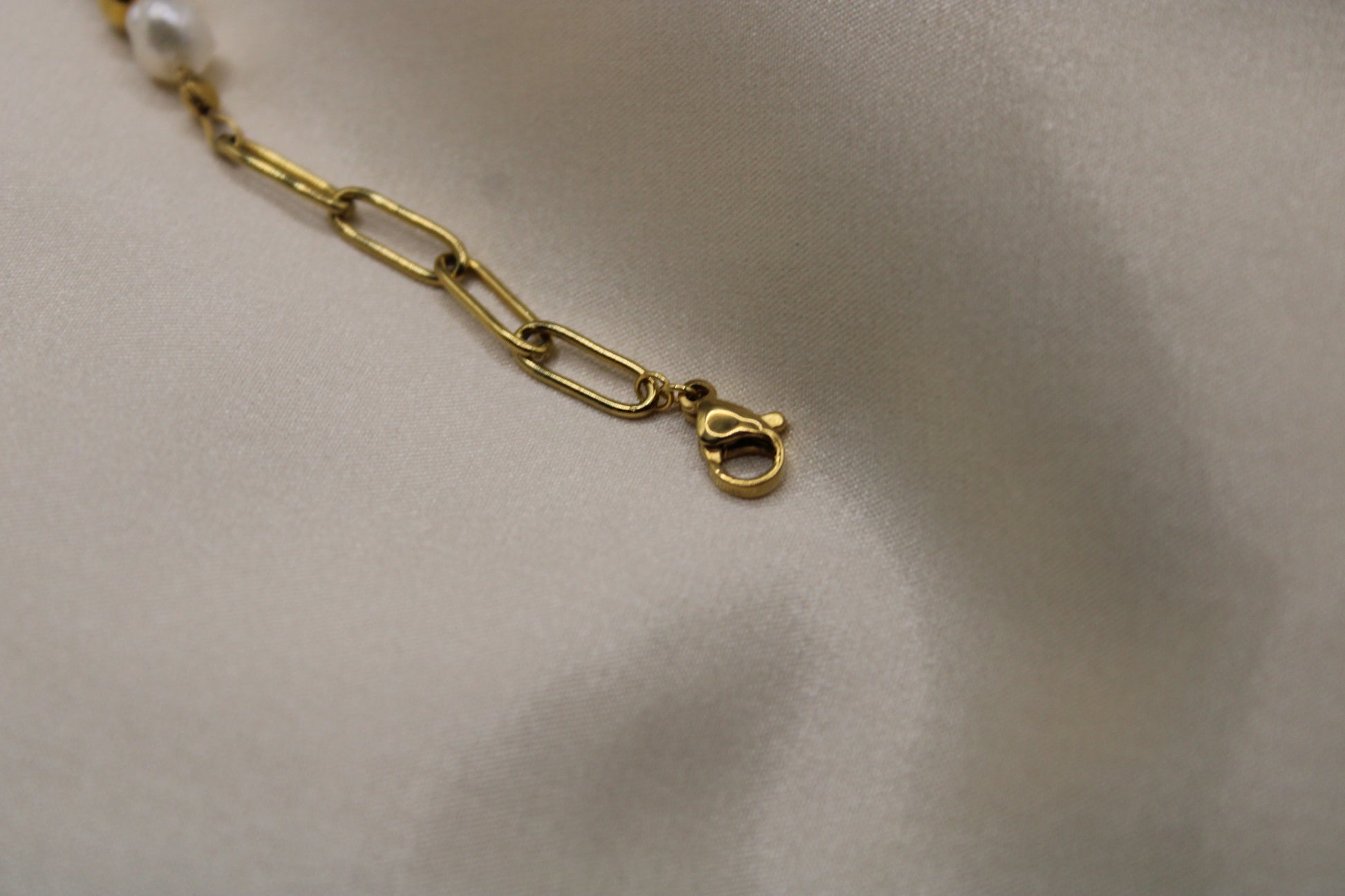 Elegante armband van stainless steel met goudkleurige afwerking, zoetwaterparels en stainless steel kralen.