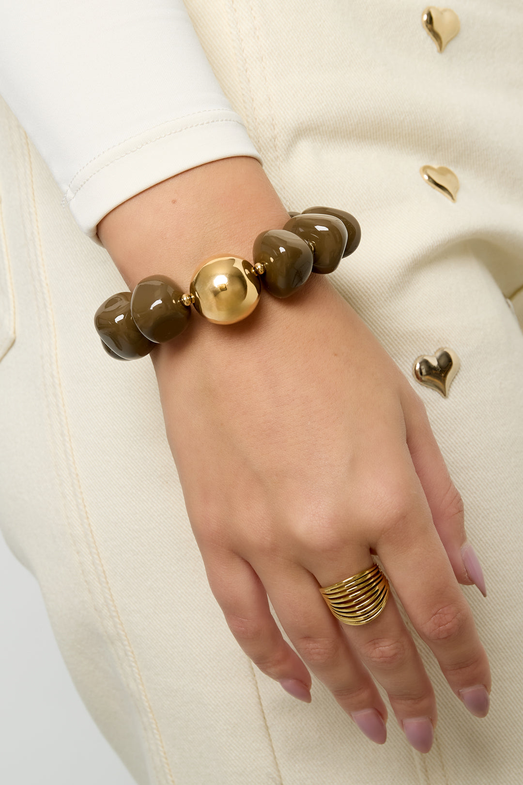 Model draagt bruine retro kralenarmband om de pols