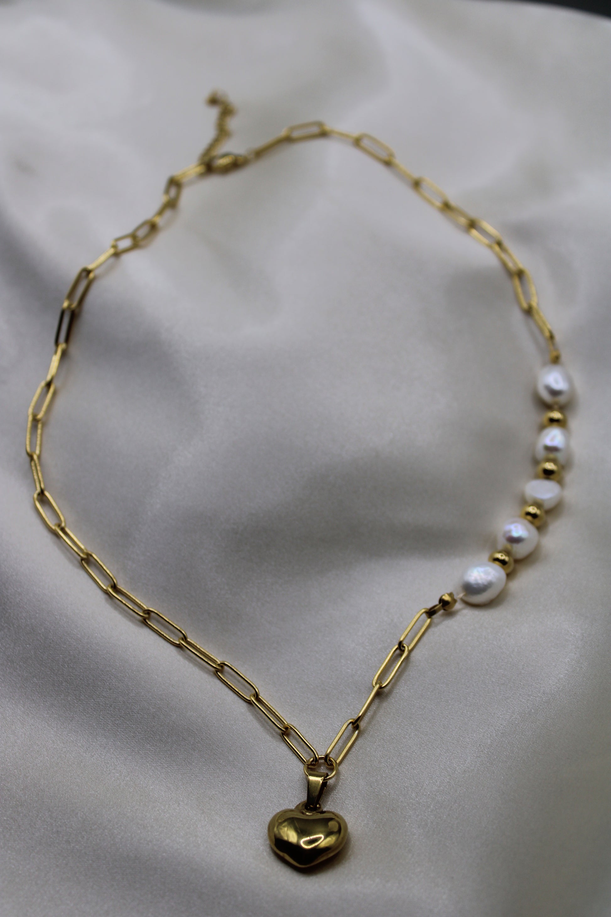 Goudkleurige ketting van stainless steel met zoetwaterparels en stijlvolle kralen.